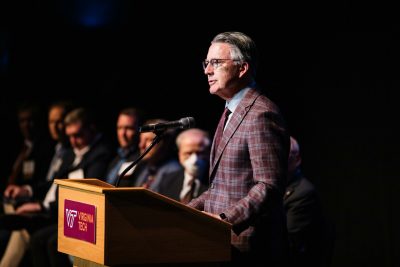President Tim Sands speaks at a podium