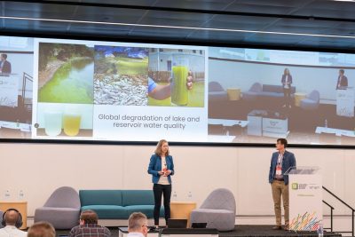 Cayelan Carey and Quinn Thomas (from left) present on a stage.