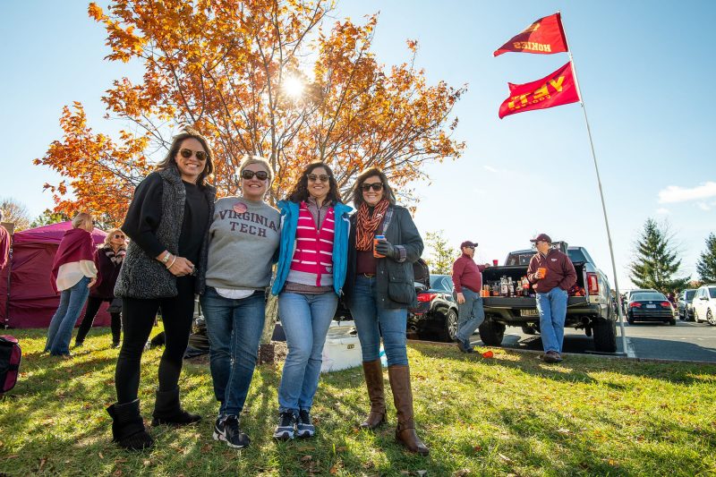 Students at football tailgate Four students posing outside a football tailgate event