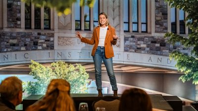 Liz Lazor talks on a stage.